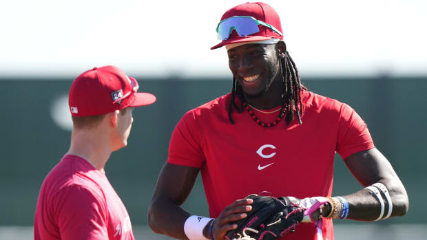 Cincinnati Reds third baseman Elly De La Cruz (44) and Cincinnati Reds shortstop Matt McLain (9) share a high during spring training workouts, Wednesday, Feb. 14, 2024, at the team s spring training facility in Goodyear, Ariz.  